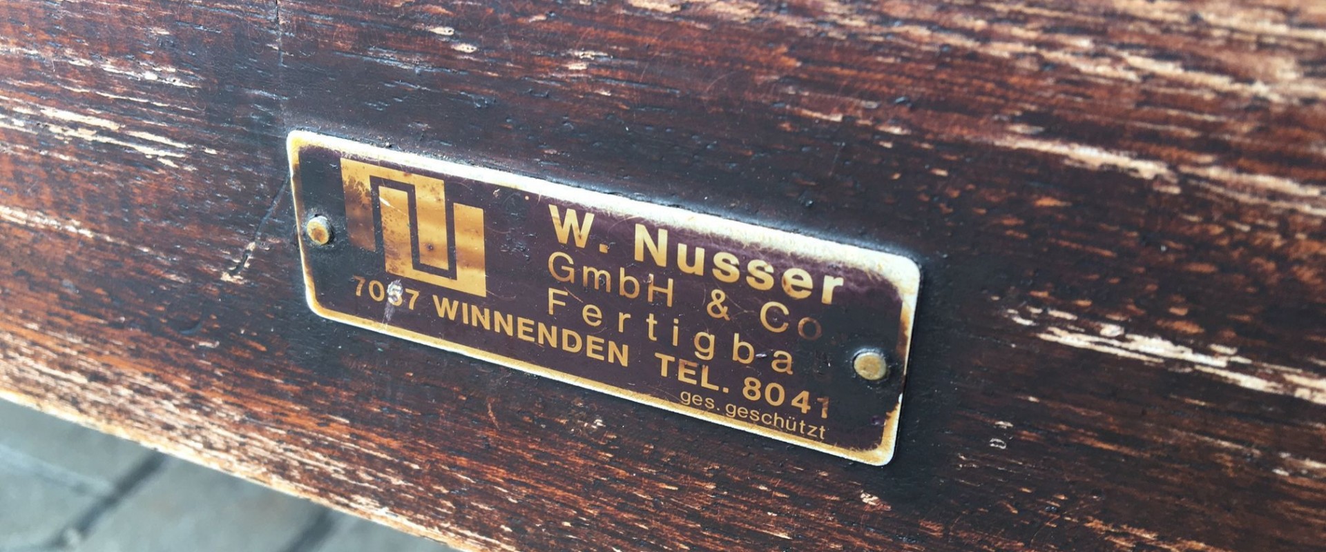 Marke der NUSSER GmbH und Co. KG auf einer Bank